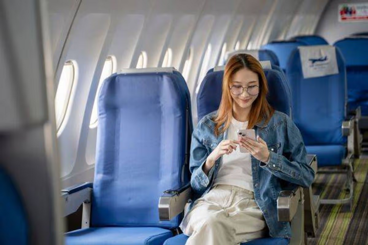 0-asian-female-tourist-with-tablet-and-mobile-phone-checking-travel-itinerary-on-passenger-plane-16375491-1792458554851-1792458555388403141652